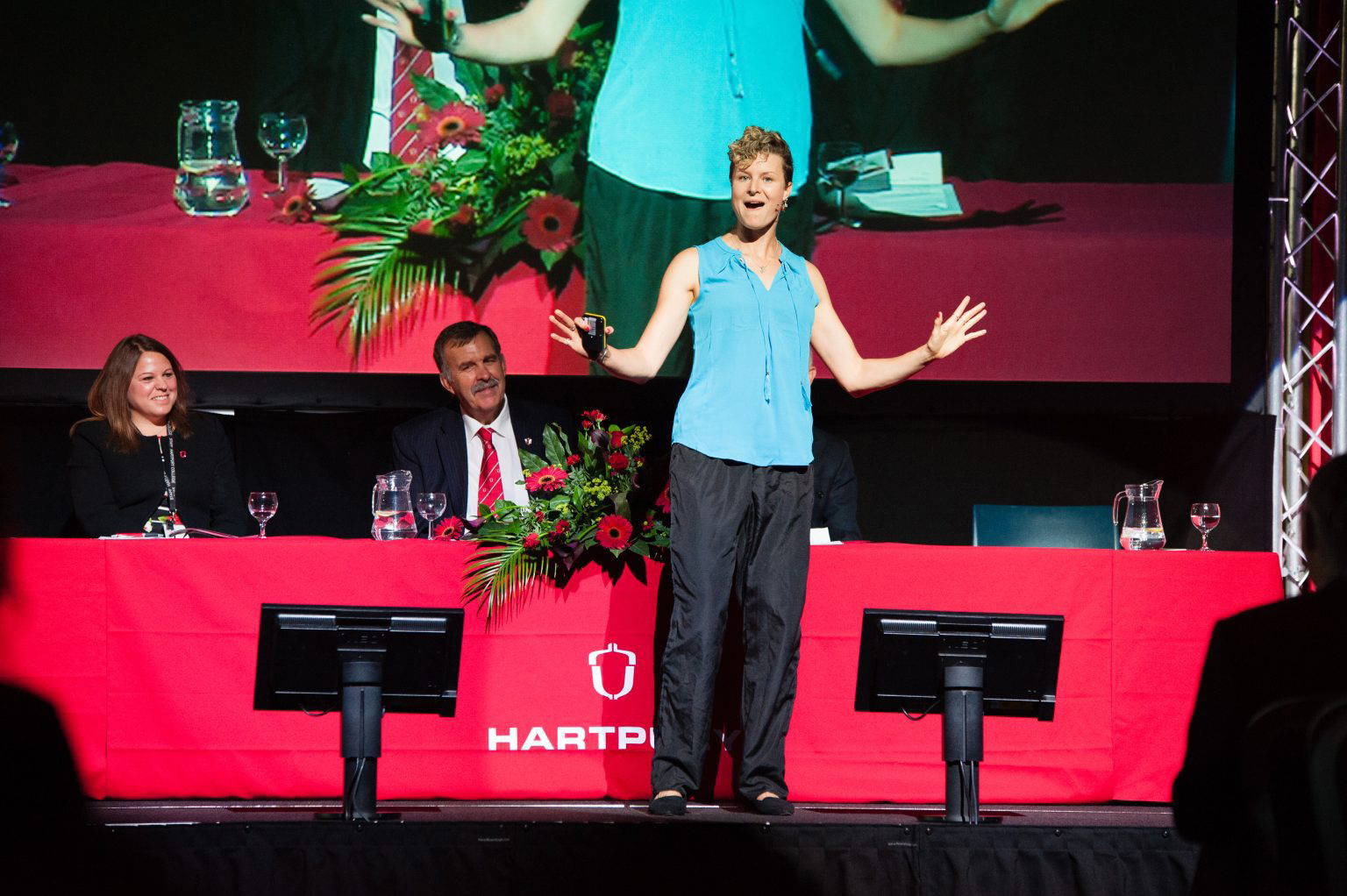 Anna McNuff giving a speech day keynote on stage in front of the top table