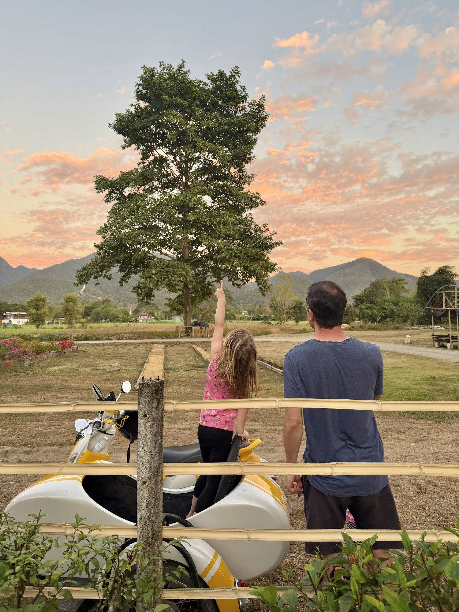 Jamie McDonald and his daughter watching the sunset over the mountains